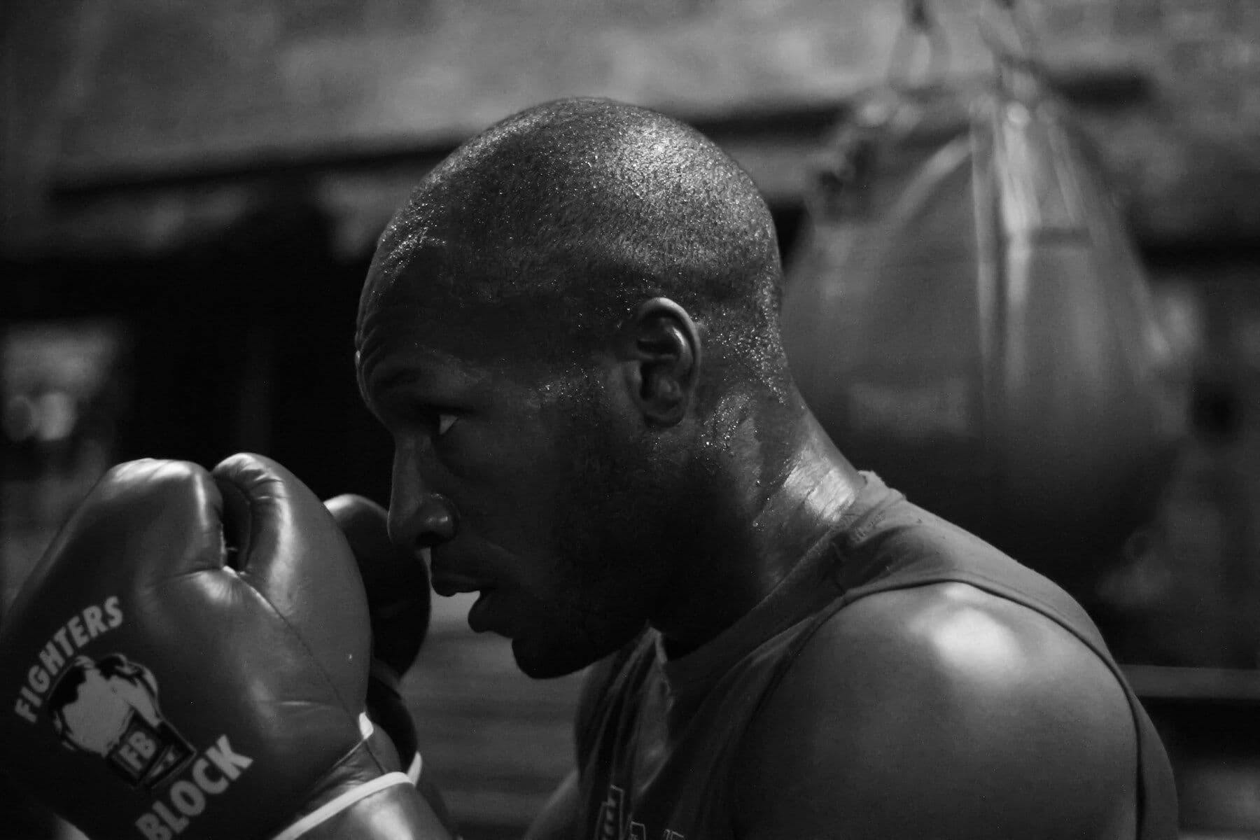 Boxer in a monochrome close-up, gloves raised