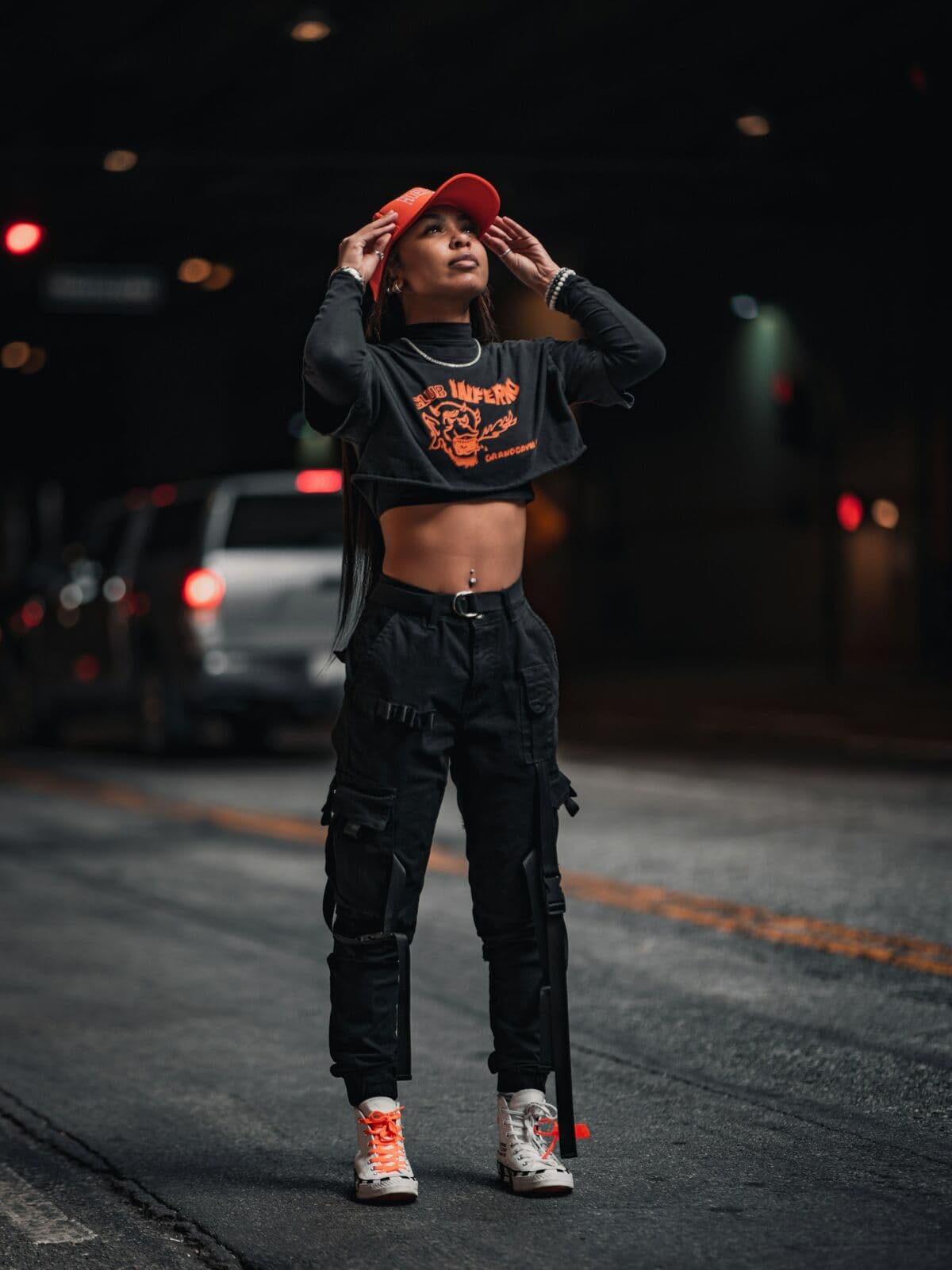 Model in black cargo pants on a street at night